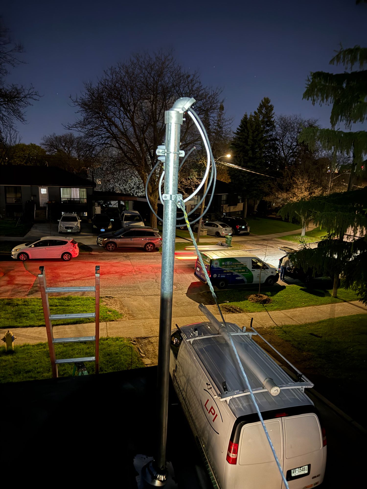 Emergency electrical service entrance mast repair at night by Safe Electrical Solutions Toronto