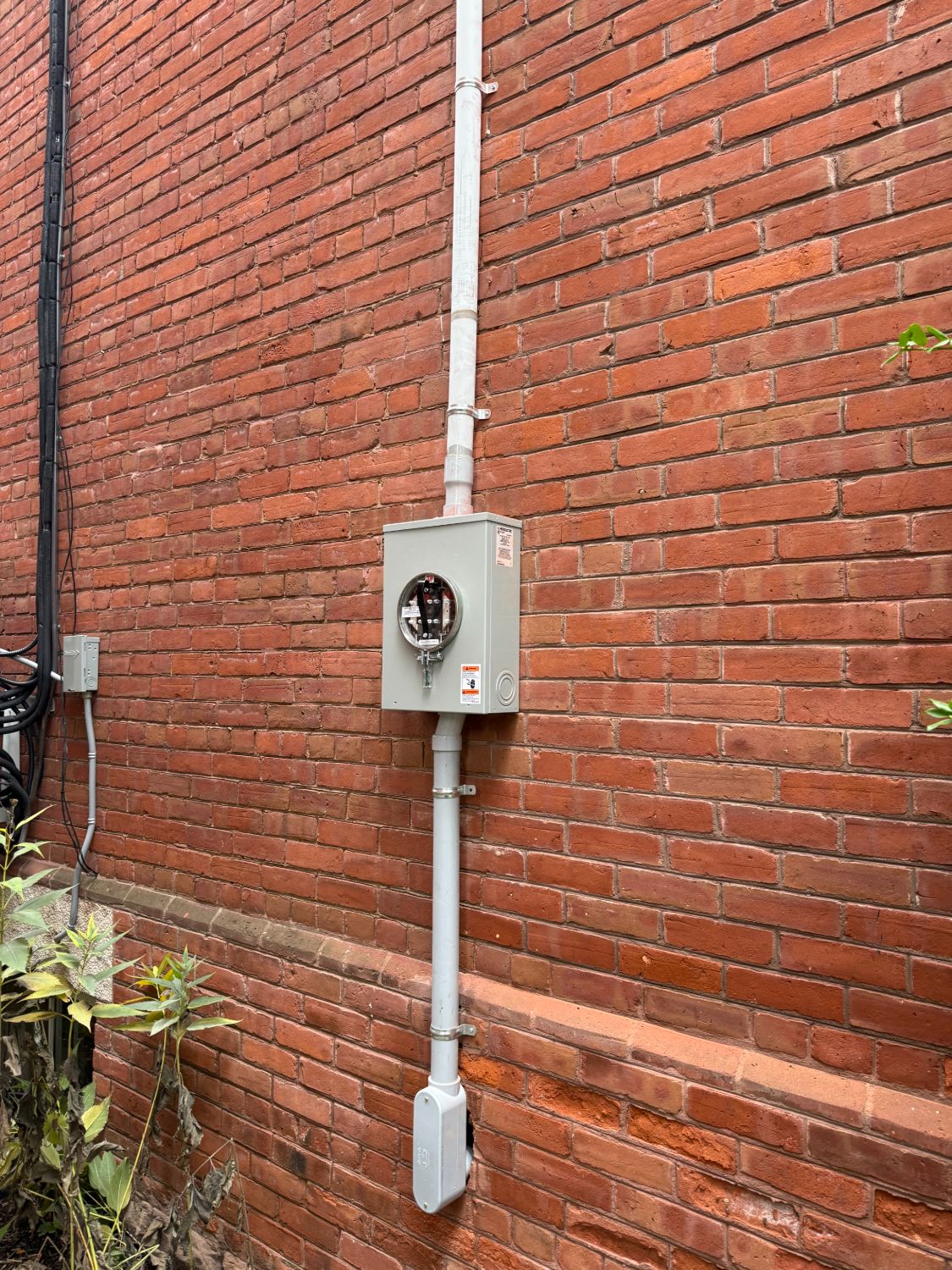 New meter socket and service entrance installed on Toronto brick exterior by licensed electrician