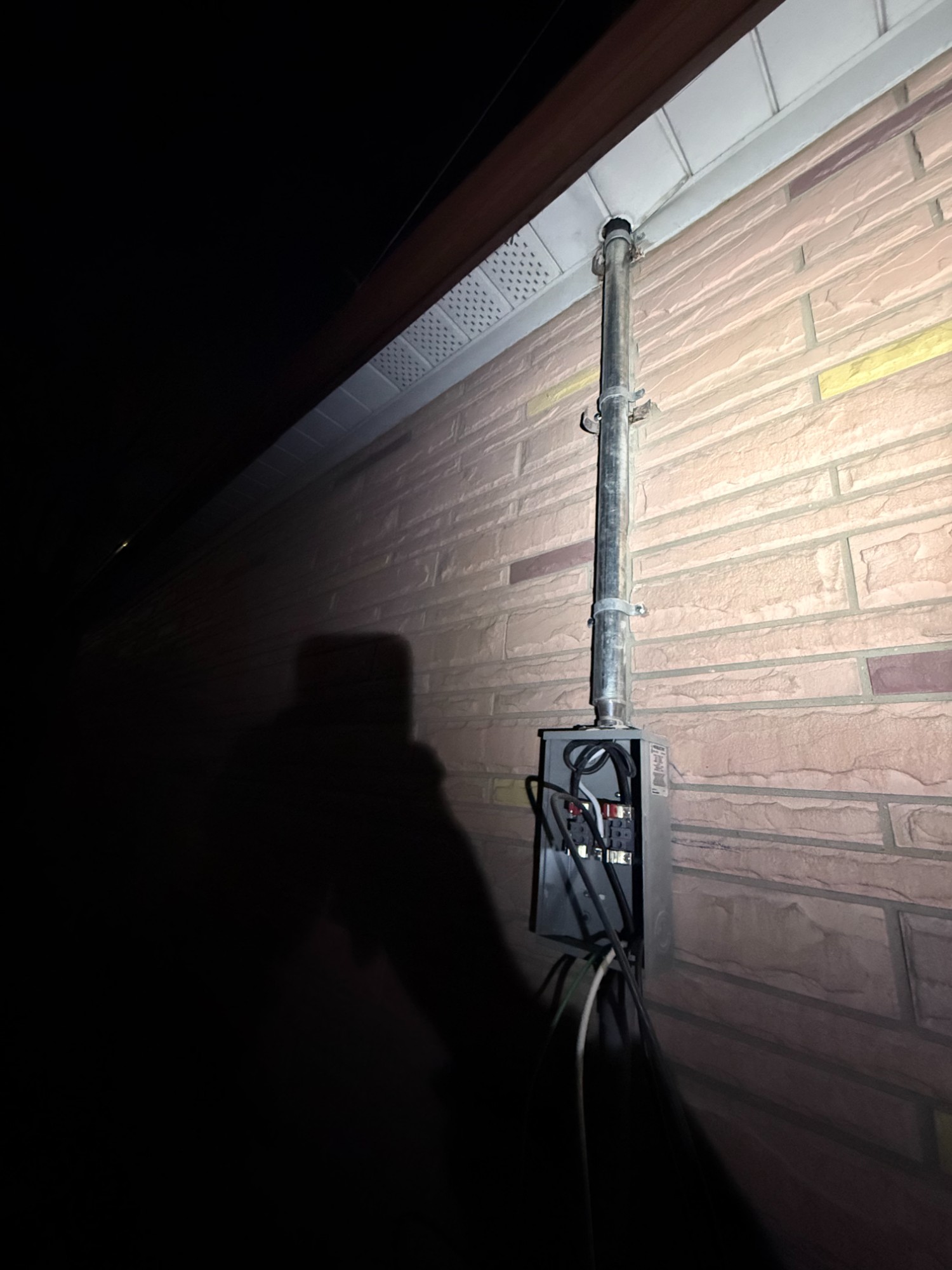 Electrical service entrance conduit installation on North York brick home by Safe Electrical Solutions